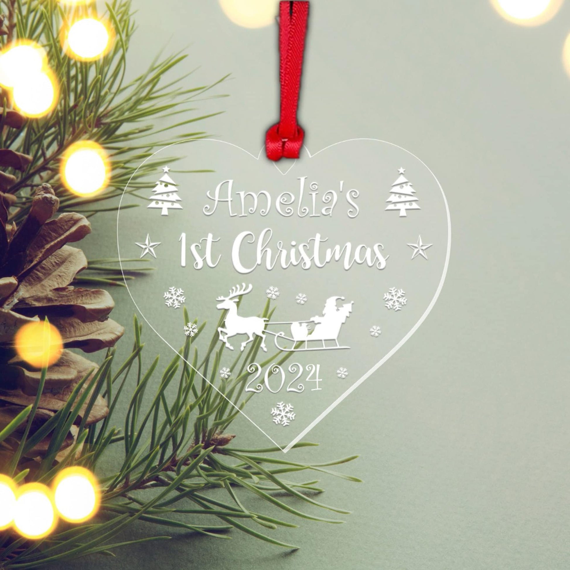a heart shaped ornament hanging from a christmas tree