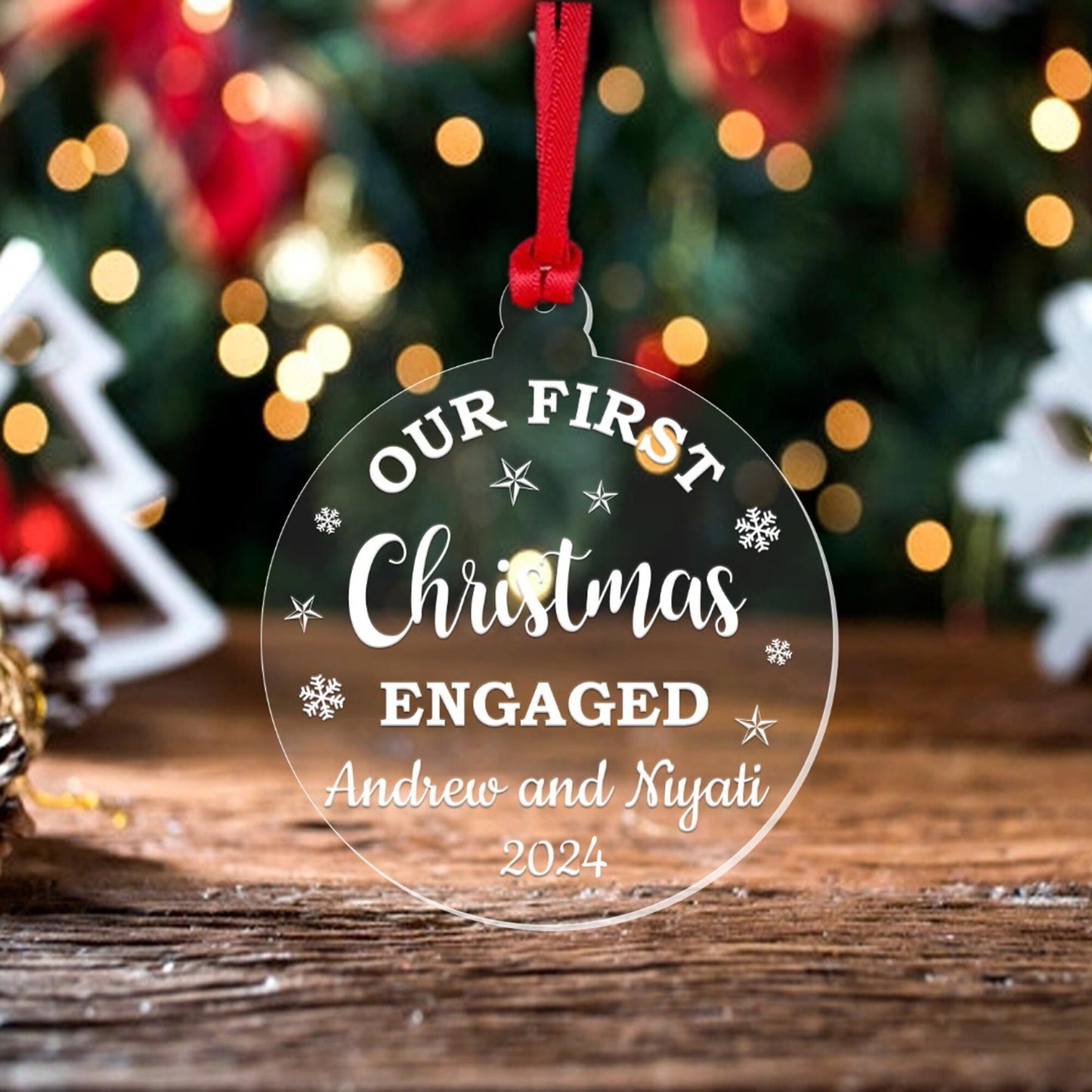 a glass ornament with the words our first christmas engaged