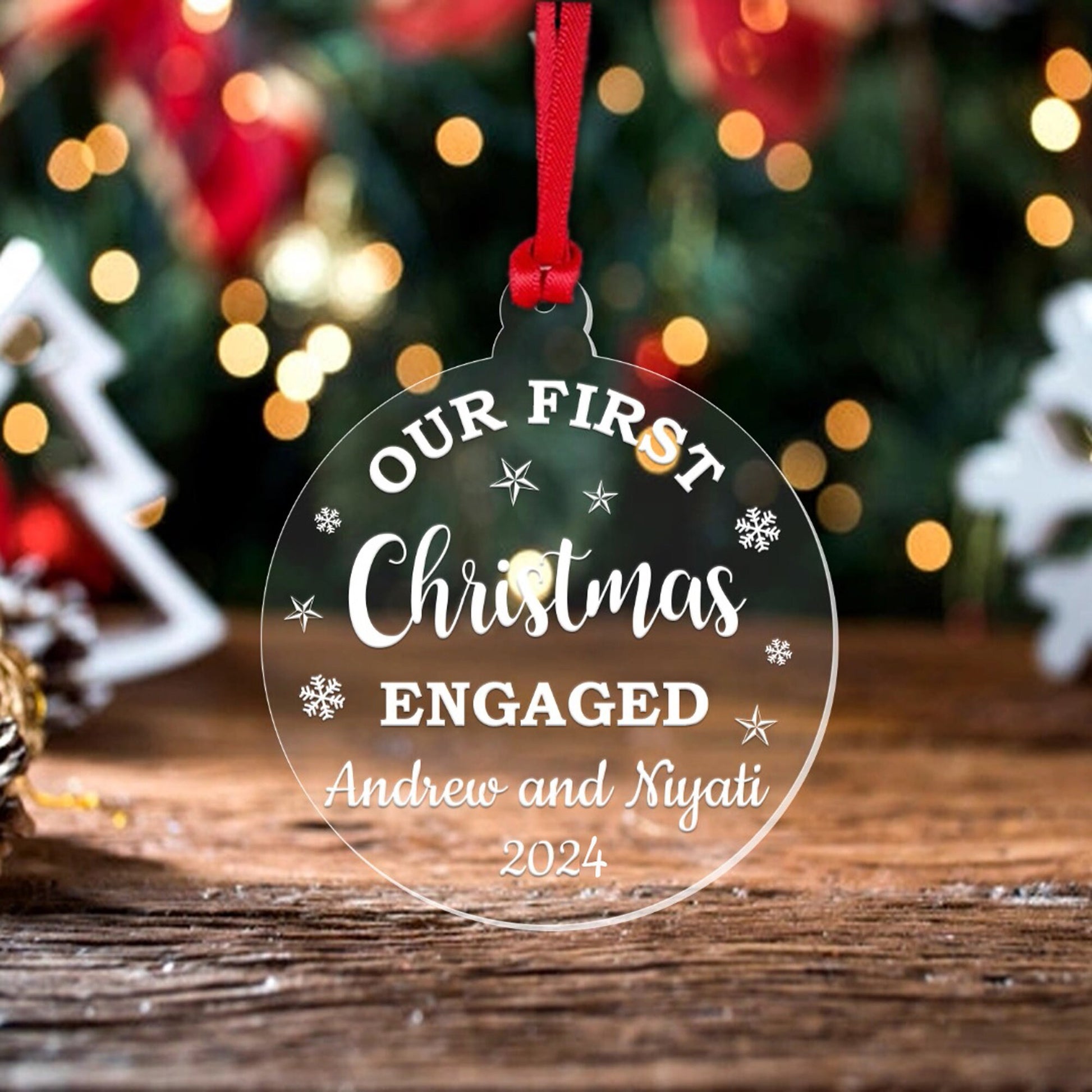 a glass ornament with the words our first christmas engaged